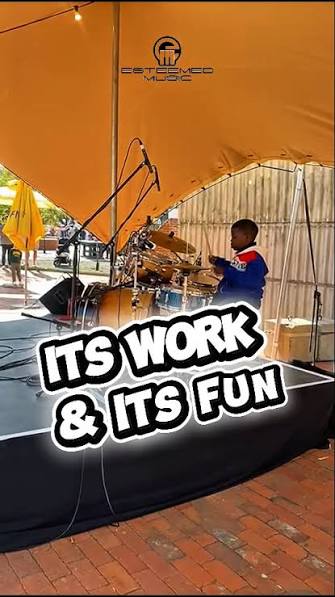 Young student playing drums outdoors at an Esteemed Music event